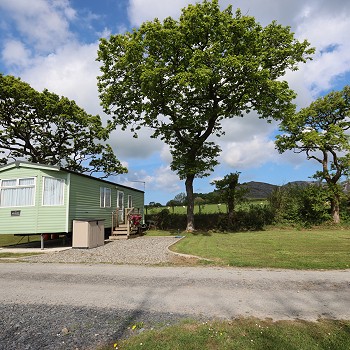 static caravan with mountains behind it