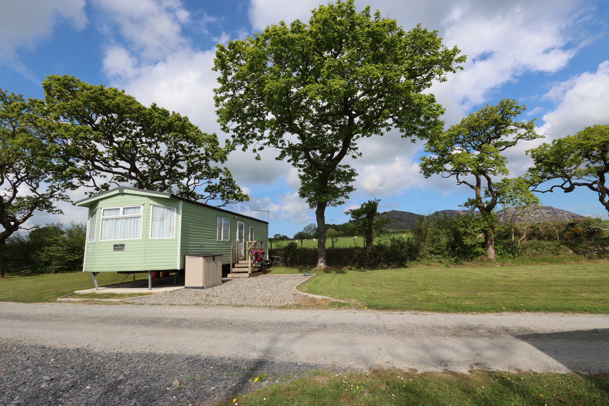 static caravan with mountains behind it