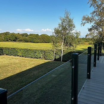 Outside the green Swift Mosell caravan looking towards the beautiful green garden