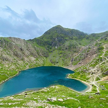 Aerial view of a lake infront of Y Wyddfa